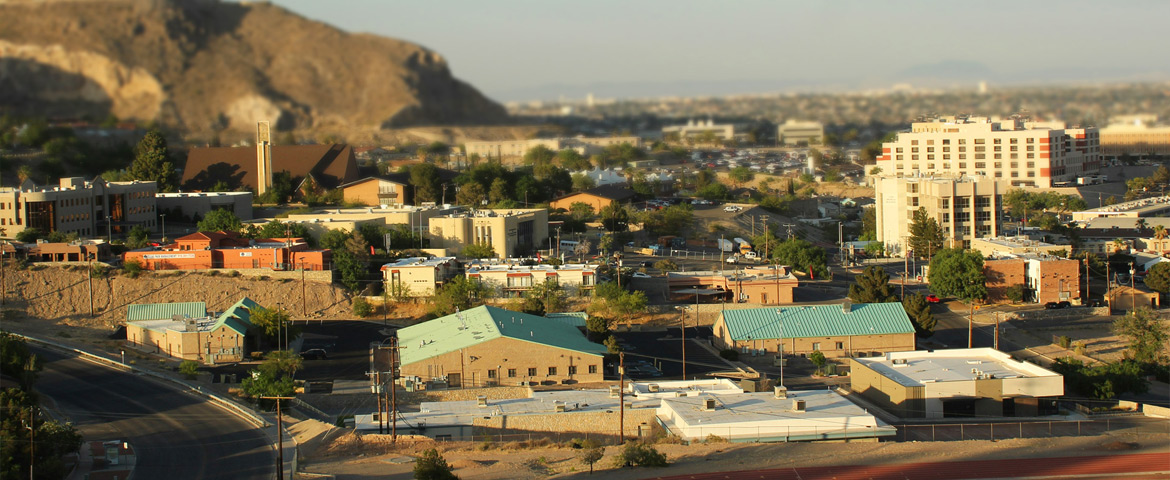 Panoramic view of the El Paso neighborhoods and the Franklin Mountains silhouette under a clear blue sky