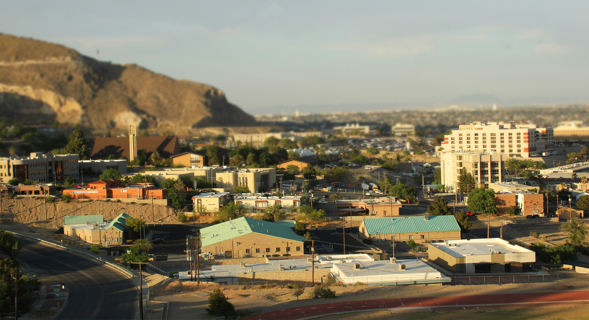 Panoramic view of El Paso neighborhoods and the Franklin Mountains silhouette under a clear blue sky